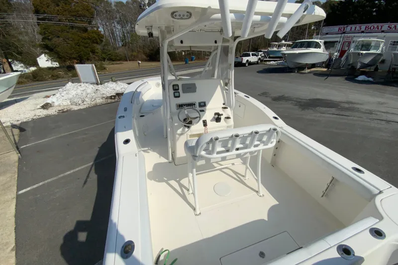 Slide: The Image of 2014 Tidewater 250 CC Adventure boat with center console, displayed at a dealership. - 9