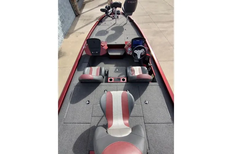 Slide: The Image of 2020 Vexus AVX 1980 boat interior with red and gray seating, steering console, and carpeted deck. - 13