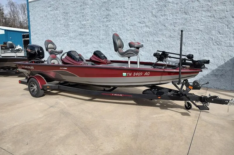 Slide: The Image of 2020 Vexus AVX 1980 boat on trailer, red and gray, parked outdoors. - 16