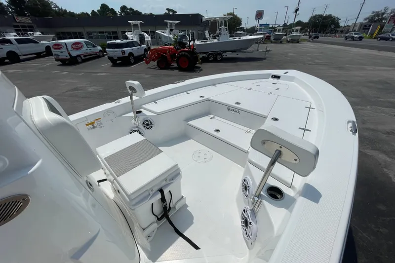 Slide: The Image of 2023 BlackJack 256 Bay boat interior with seating and storage, displayed outdoors. - 13