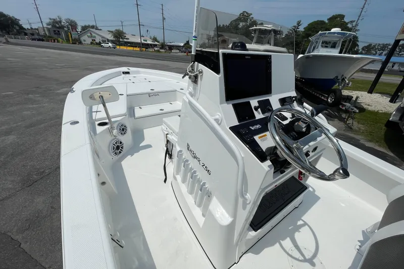 Slide: The Image of 2023 BlackJack 256 Bay boat interior with steering console and seating. - 16