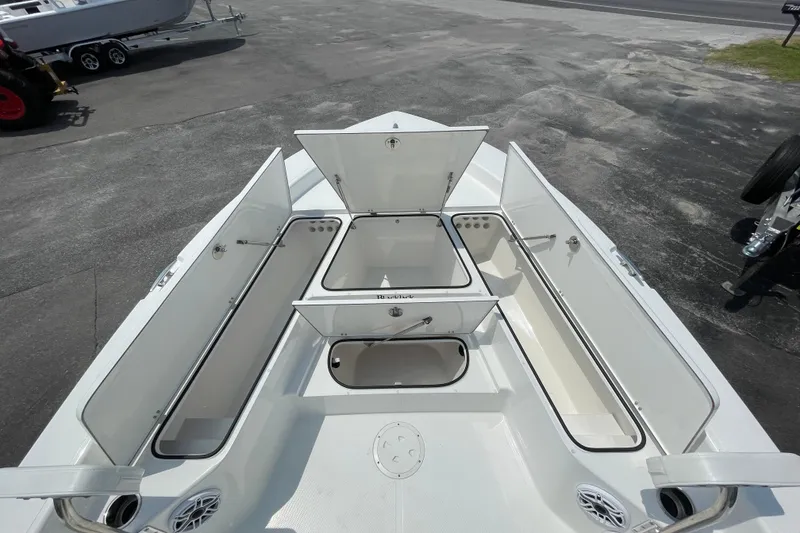 Slide: The Image of 2023 BlackJack 256 Bay boat with open storage compartments on deck. - 19