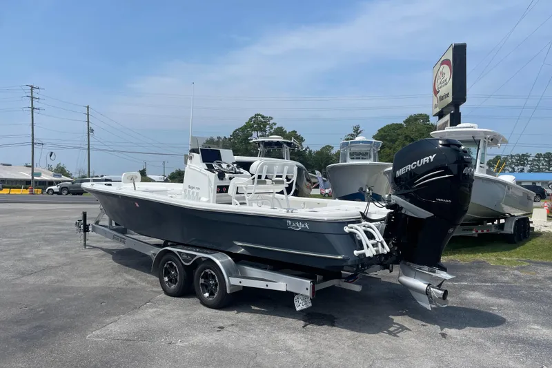 Slide: The Image of 2023 BlackJack 256 Bay boat with Mercury engine on trailer in dealership lot. - 3
