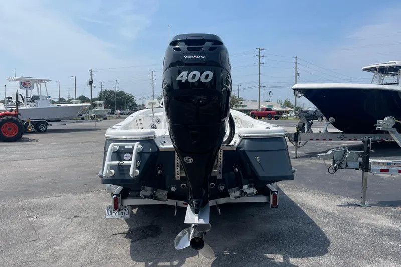 Slide: The Image of 2023 BlackJack 256 Bay boat with powerful 400 Verado engine in a marina setting. - 4