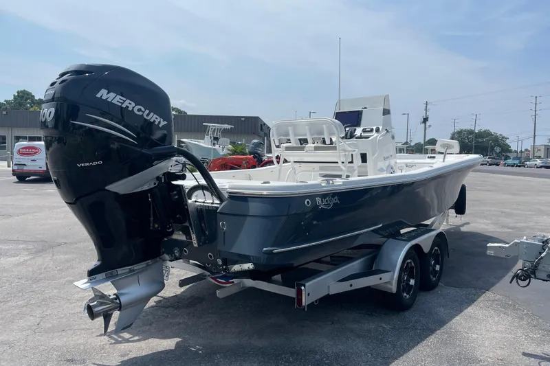 Slide: The Image of 2023 BlackJack 256 Bay boat with Mercury Verado engine on a trailer. - 5