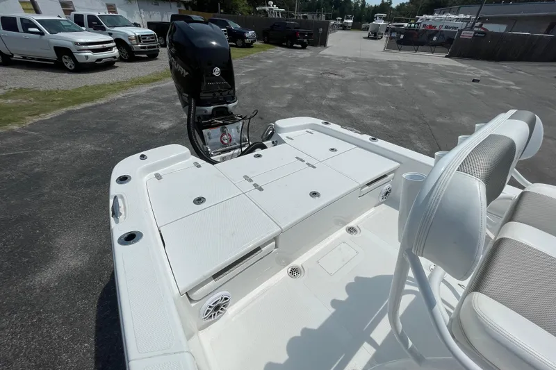 Slide: The Image of 2023 BlackJack 256 Bay boat with Mercury engine, parked outdoors. - 7