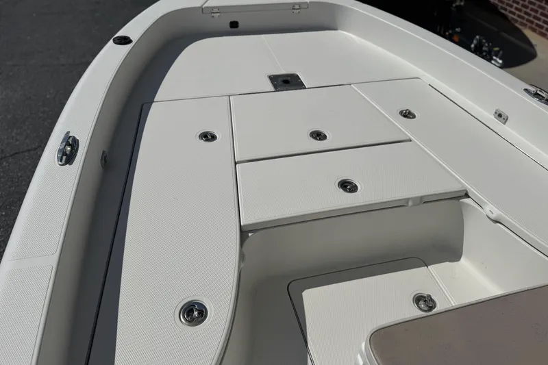 Slide: The Image of 2012 Ranger 2410 Bay Ranger boat deck with storage compartments, white finish. - 11