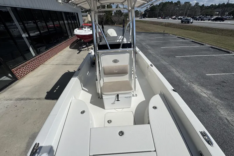 Slide: The Image of 2012 Ranger 2410 Bay Ranger boat parked outside dealership, showcasing spacious deck. - 13
