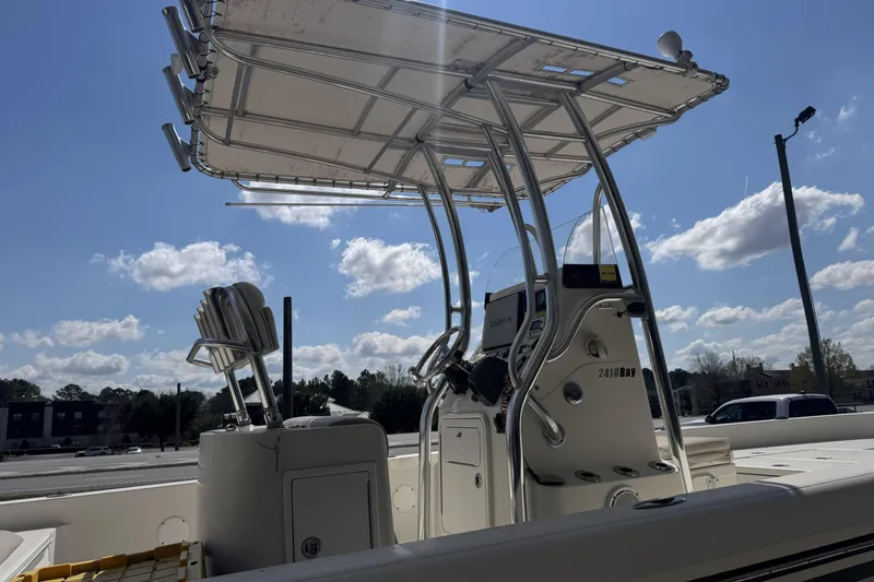 Slide: The Image of 2012 Ranger 2410 Bay Ranger boat with T-top under a clear blue sky. - 16