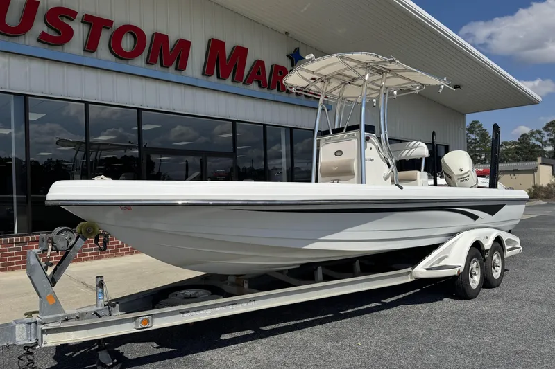 Slide: The Image of 2012 Ranger 2410 Bay Ranger boat on trailer outside Custom Marine store. - 6