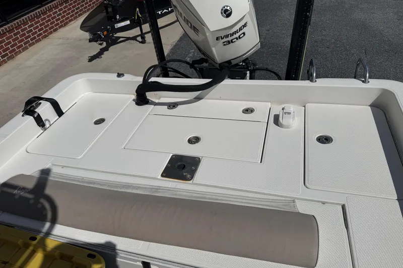 Slide: The Image of 2012 Ranger 2410 Bay Ranger boat deck with Evinrude 300 engine, featuring storage compartments. - 9