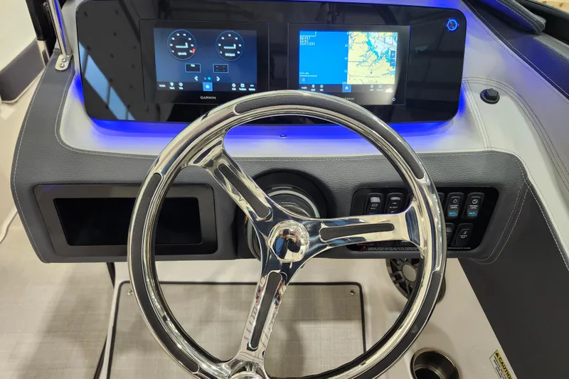 Slide: The Image of 2025 Regal LX2 boat dashboard with modern steering wheel and digital displays. - 16