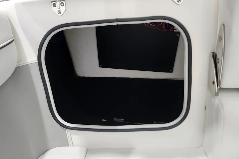 Slide: The Image of 2025 Regal LX2 boat storage compartment with sleek white interior design. - 21