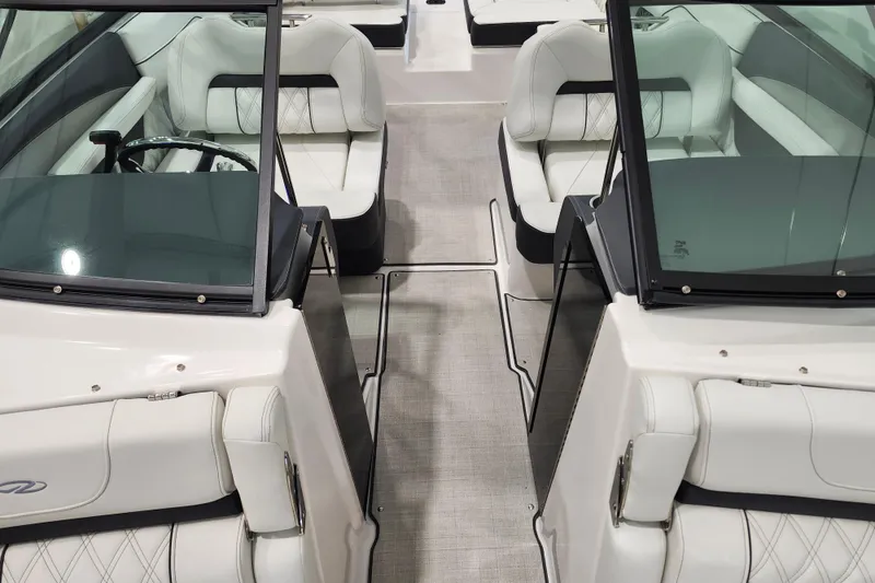 Slide: The Image of 2025 Regal LX2 boat interior with luxurious white seating and sleek design. - 22