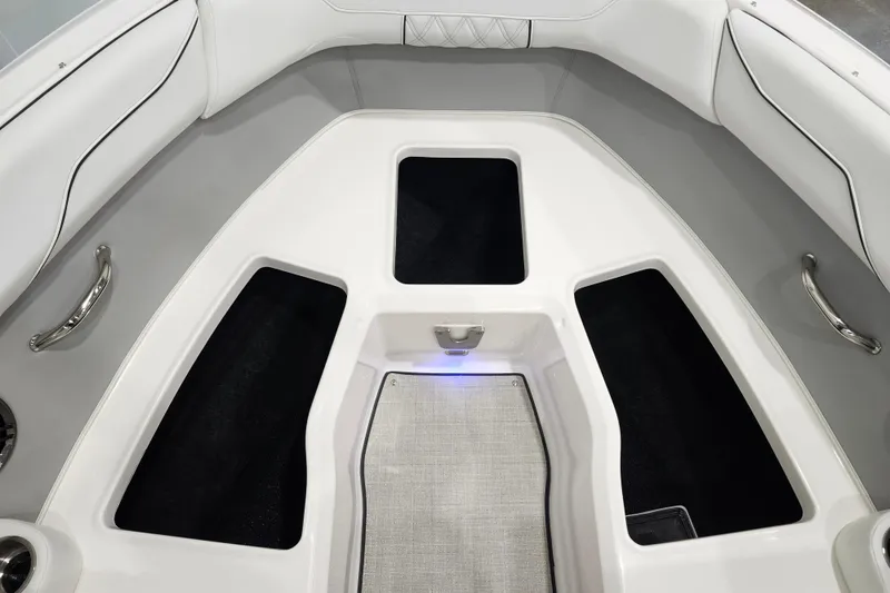 Slide: The Image of 2025 Regal LX2 boat interior with sleek white seating and storage compartments. - 24