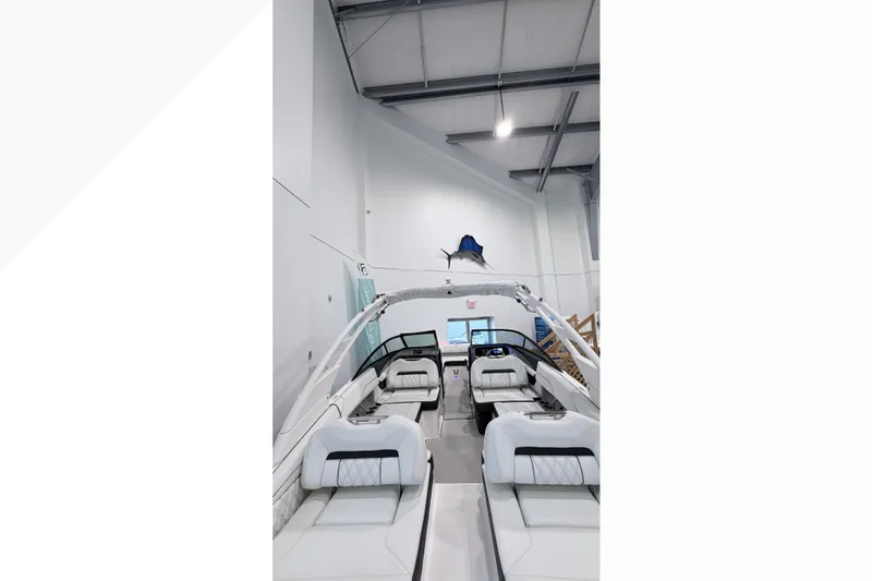 Slide: The Image of 2025 Regal LX2 boat interior with sleek seating in a showroom. - 7
