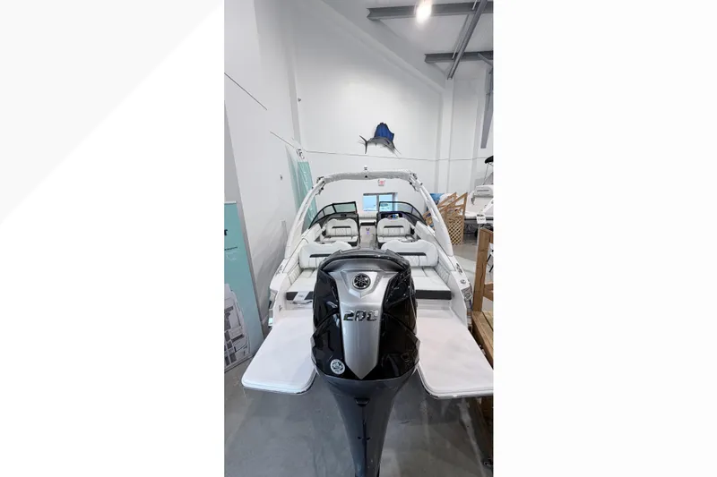Slide: The Image of 2025 Regal LX2 boat with sleek design and modern interior in showroom. - 9
