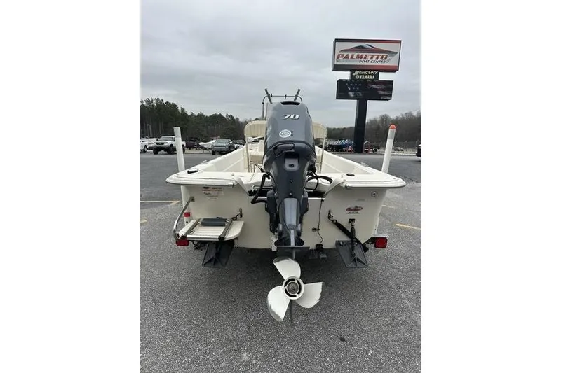 Slide: The Image of 2014 Carolina Skiff JV Series 17 SS/TH/CC boat with outboard motor, parked outdoors. - 6