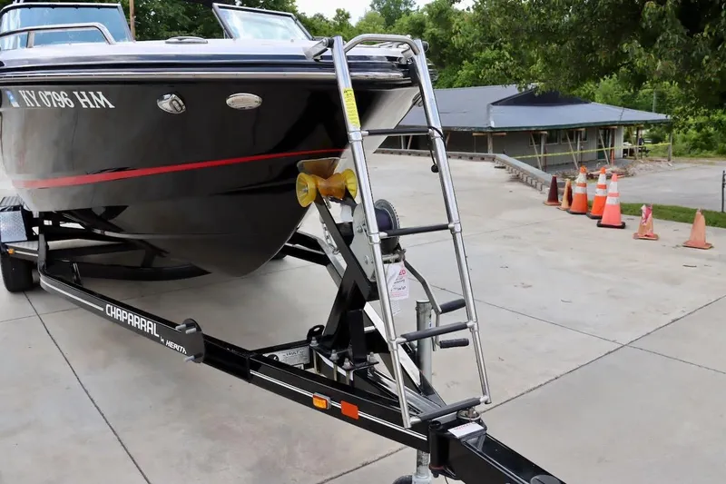 Slide: The Image of 2017 Chaparral 227 SSX boat on trailer, parked outdoors with traffic cones nearby. - 12