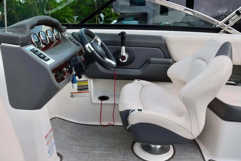 Slide: The Image of 2017 Chaparral 227 SSX boat interior with steering wheel and captain's chair. - 16