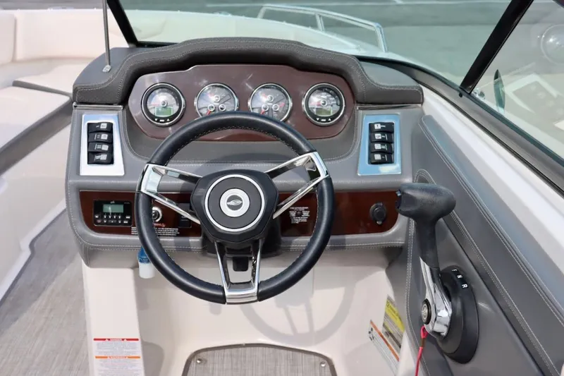 Slide: The Image of 2017 Chaparral 227 SSX boat dashboard with steering wheel and control panel. - 17