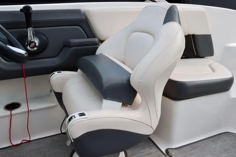 Slide: The Image of 2017 Chaparral 227 SSX boat interior with plush seating and control panel. - 18