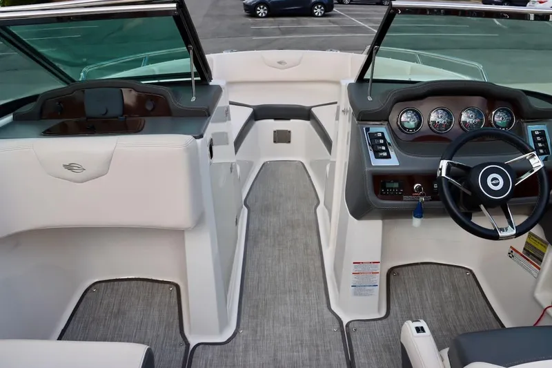 Slide: The Image of Interior view of 2017 Chaparral 227 SSX boat, featuring steering wheel and dashboard controls. - 23