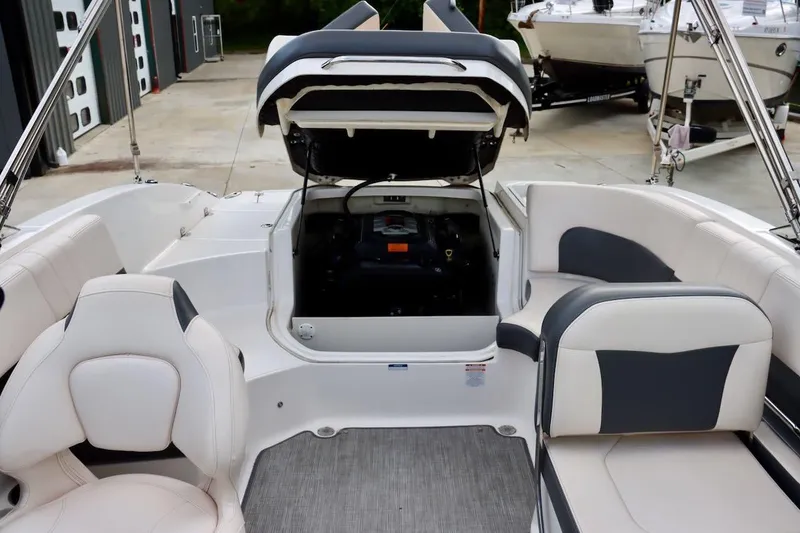 Slide: The Image of 2017 Chaparral 227 SSX boat interior with open engine compartment, showcasing seating and design. - 32