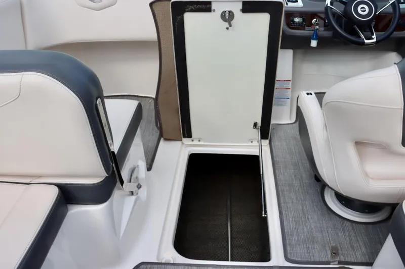 Slide: The Image of Interior view of a 2017 Chaparral 227 SSX boat, featuring seating and storage compartment. - 38