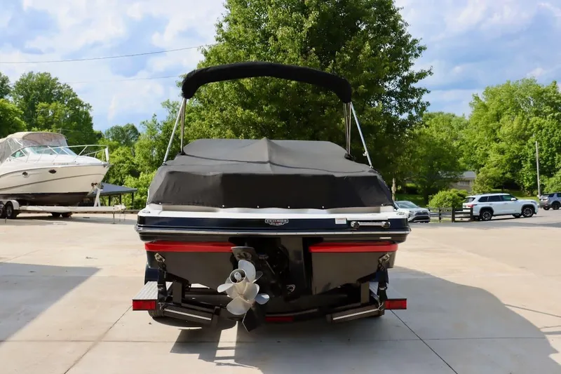 Slide: The Image of 2017 Chaparral 227 SSX boat with cover, parked outdoors on a sunny day. - 40