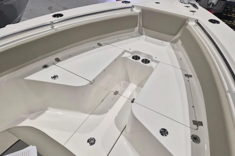 Slide: The Image of 2026 Key West 239 FS boat interior with storage compartments and cup holders. - 10