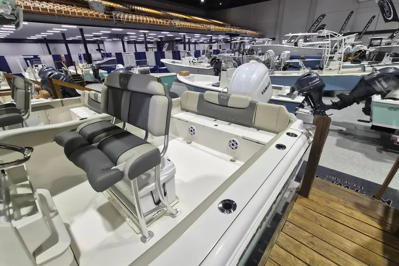 Slide: The Image of 2026 Key West 239 FS boat interior at a boat show, featuring seating and Yamaha engines. - 3