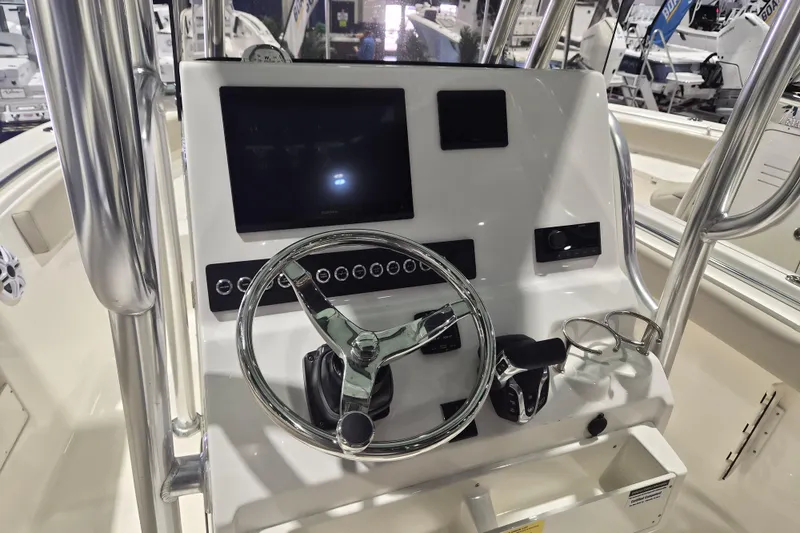 Slide: The Image of 2026 Key West 239 FS boat dashboard with steering wheel and control panel. - 5