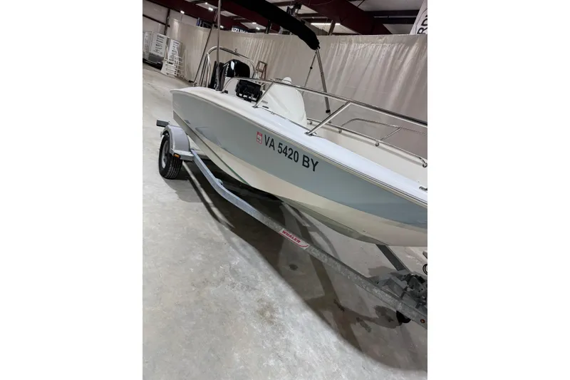 The Image of 2015 Boston Whaler 150 Super Sport boat on trailer in indoor storage. - 0