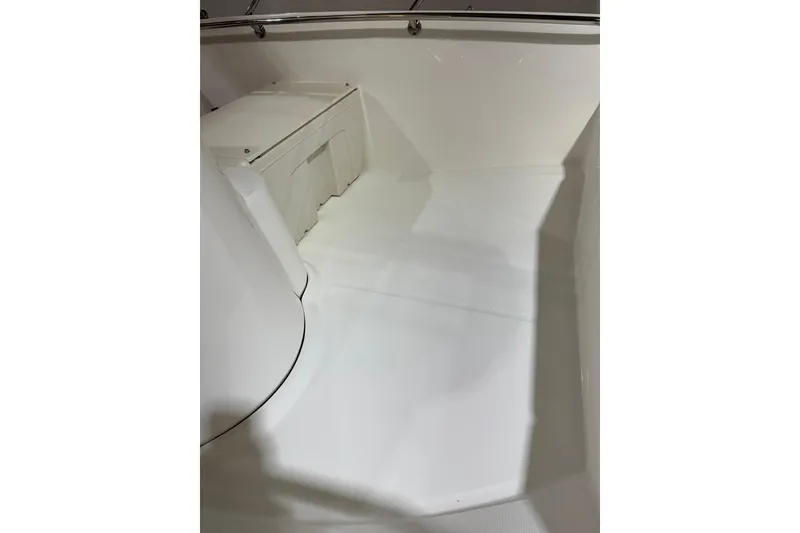 Slide: The Image of 2015 Boston Whaler 150 Super Sport interior, featuring clean white deck and seating area. - 11