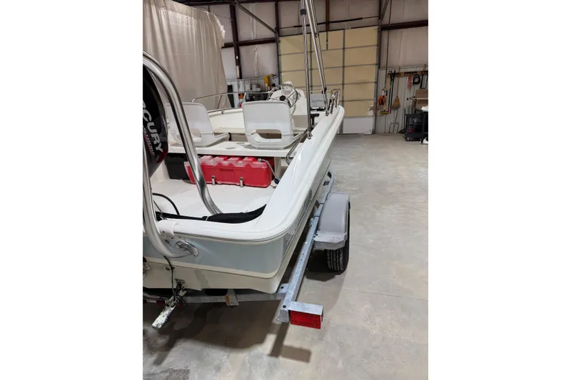 Slide: The Image of 2015 Boston Whaler 150 Super Sport boat on trailer in a garage. - 5
