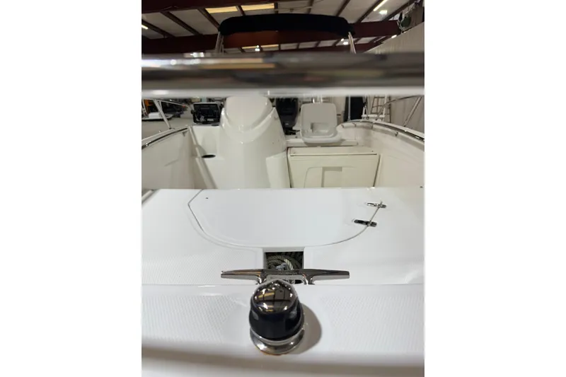Slide: The Image of 2015 Boston Whaler 150 Super Sport boat interior with seating and storage compartments. - 9