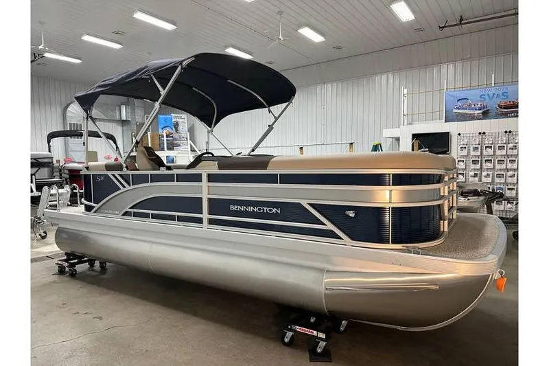 The Image of 2026 Bennington 21 SSR Quad Bench pontoon boat in showroom, featuring sleek design. - 1