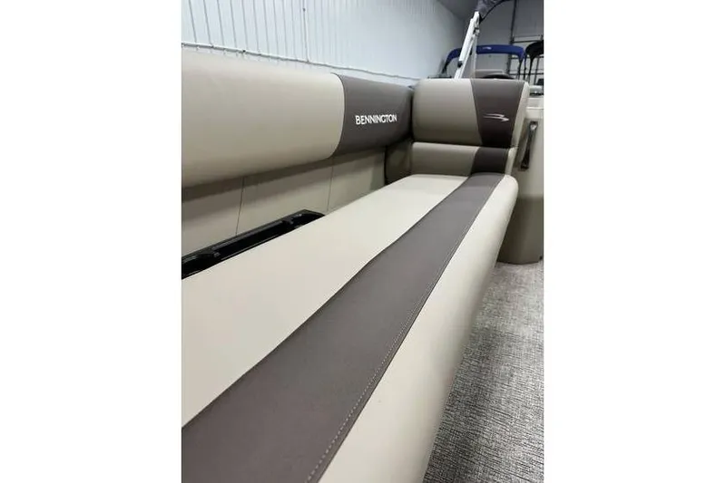 Slide: The Image of 2026 Bennington 21 SSR Quad Bench interior, featuring beige and brown seating. - 13