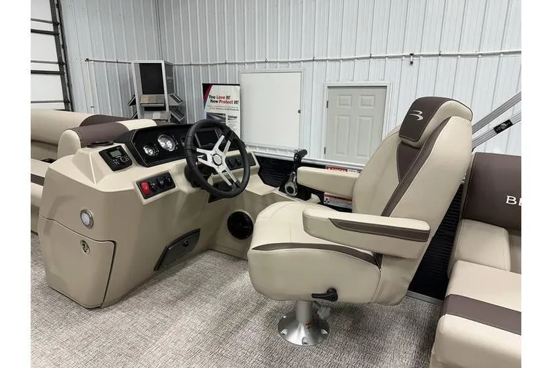 Slide: The Image of 2026 Bennington 21 SSR Quad Bench boat interior with captain's chair and steering console. - 24