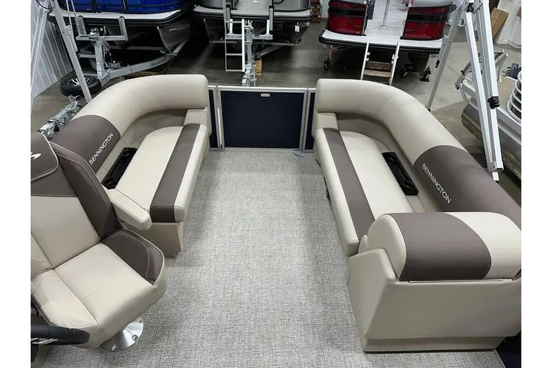 Slide: The Image of 2026 Bennington 21 SSR Quad Bench interior with beige and brown seating. - 26