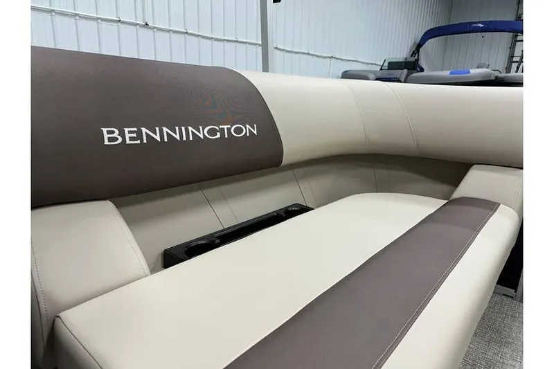 Slide: The Image of 2026 Bennington 21 SSR Quad Bench interior seating in stock, featuring elegant beige and brown upholstery. - 27