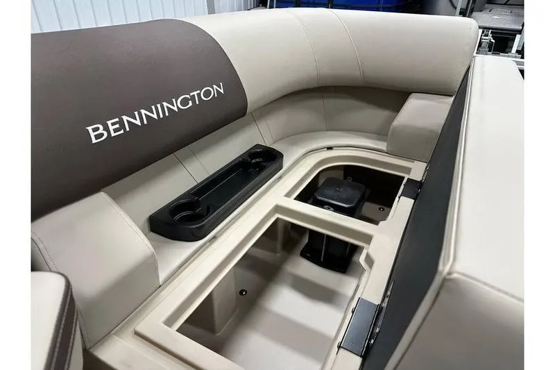 Slide: The Image of 2026 Bennington 21 SSR Quad Bench interior with storage compartment and cup holders. - 28