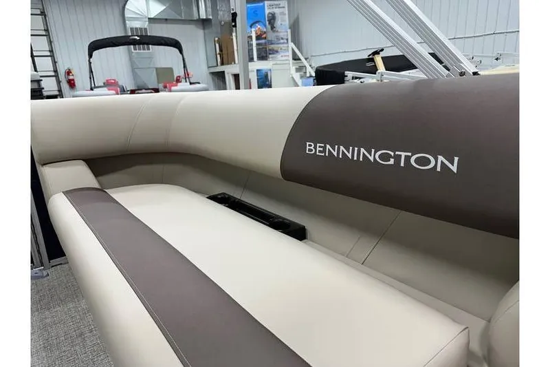 Slide: The Image of 2026 Bennington 21 SSR Quad Bench interior with beige and brown seating. - 29
