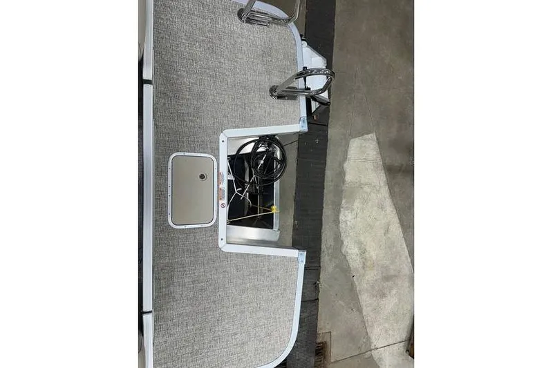 Slide: The Image of 2026 Bennington 21 SSR Quad Bench boat interior with gray upholstery and metal fixtures. - 35