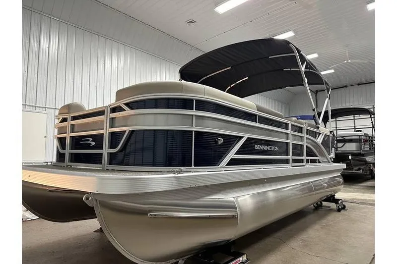 Slide: The Image of 2026 Bennington 21 SSR Quad Bench pontoon boat in stock, indoor showroom display. - 4