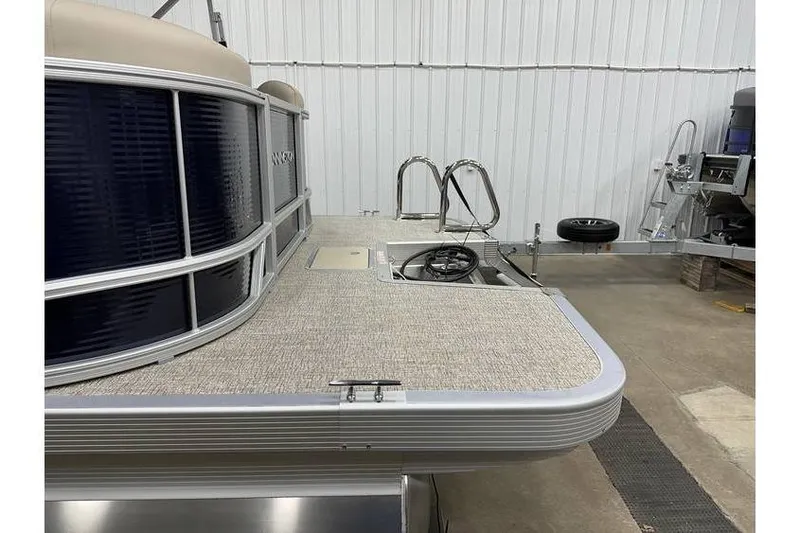 Slide: The Image of 2026 Bennington 21 SSR Quad Bench pontoon boat in stock, displayed in a showroom. - 7