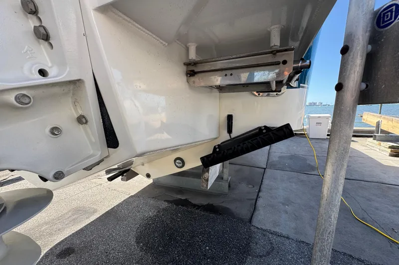 Slide: The Image of 2023 Regulator 31 boat stern detail with trim tab and propeller, dockside view. - 2