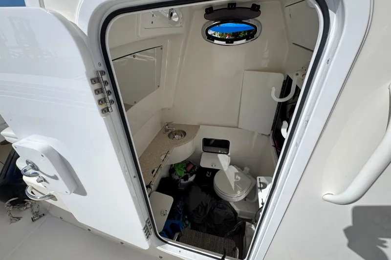 Slide: The Image of 2023 Regulator 31 boat interior cabin with toilet and sink. - 20