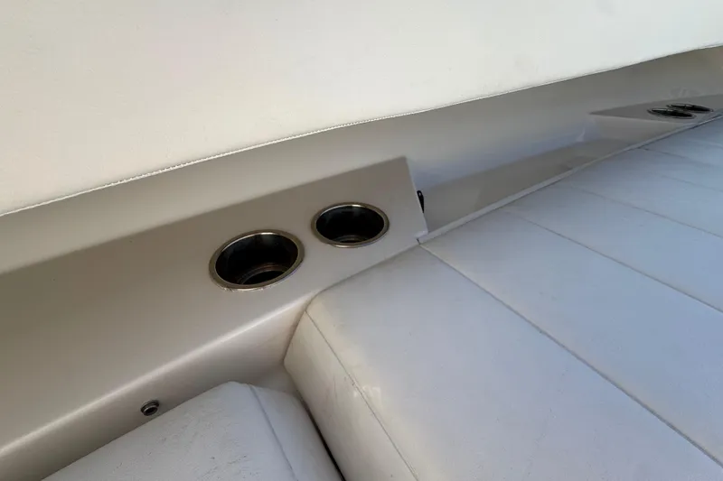 Slide: The Image of Interior of 2023 Regulator 31 boat featuring cup holders and cushioned seating. - 22